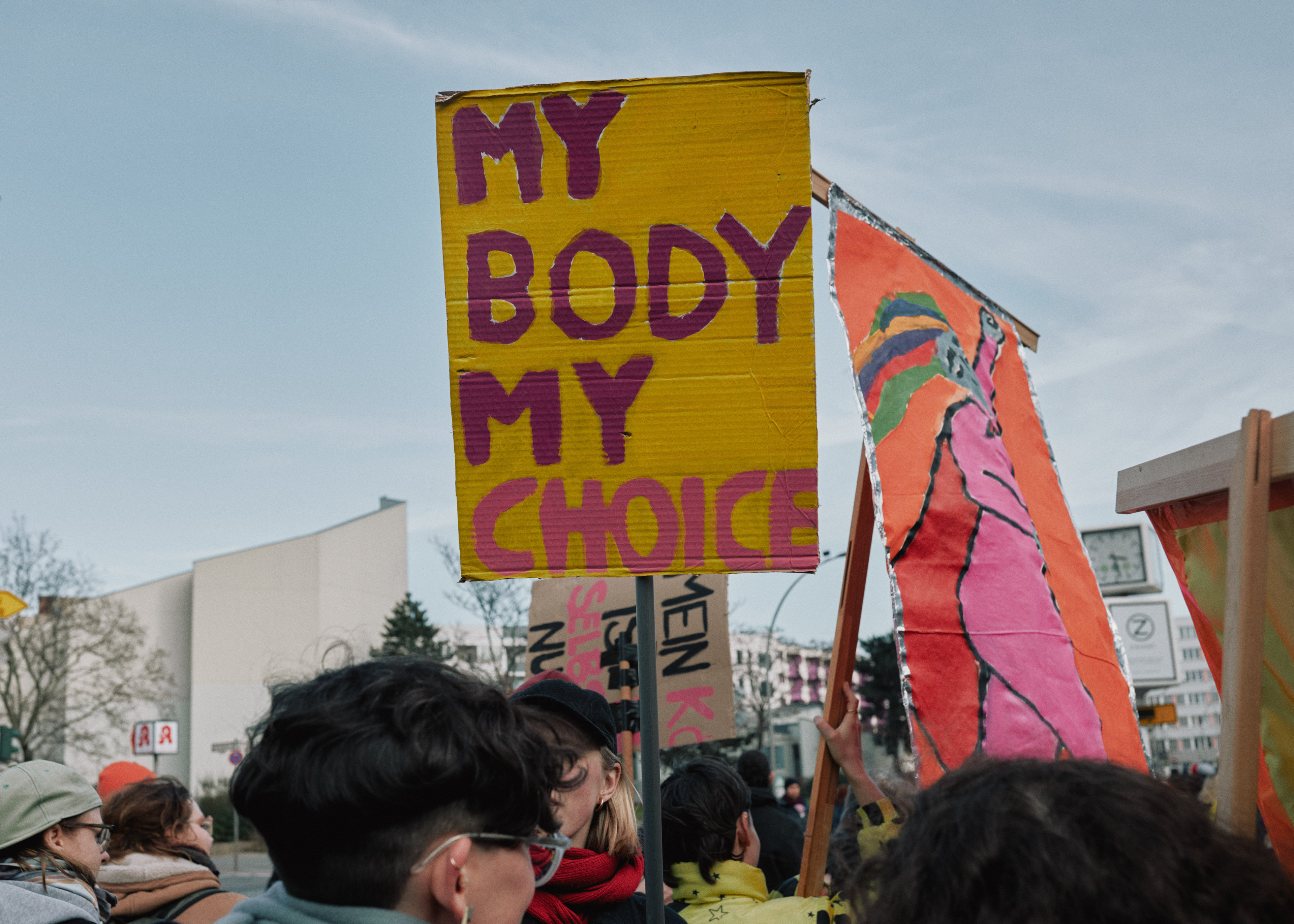 A protestor holds a sign: "My body my choice"