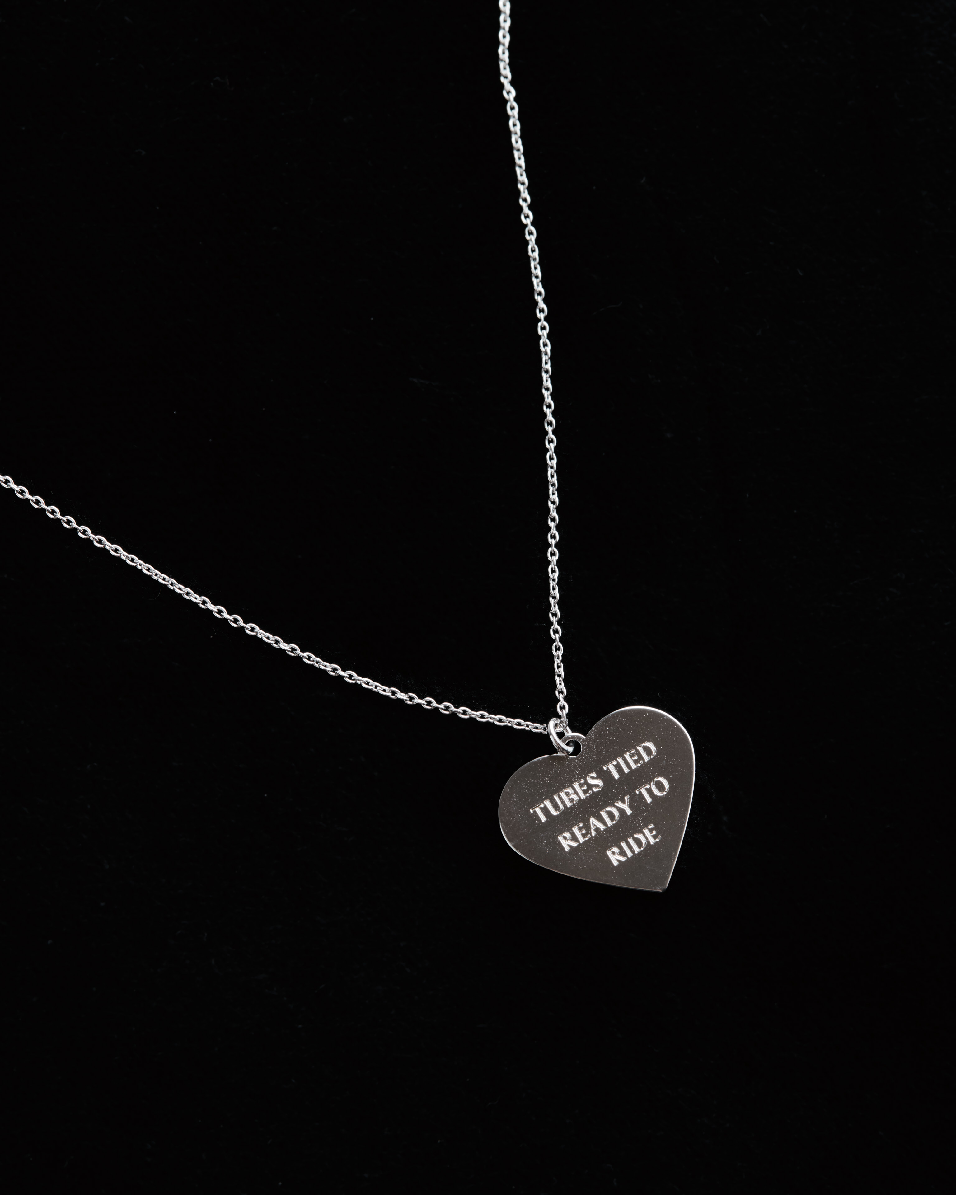 Tubes Tied Ready to Ride engraved silver heart necklace close-up